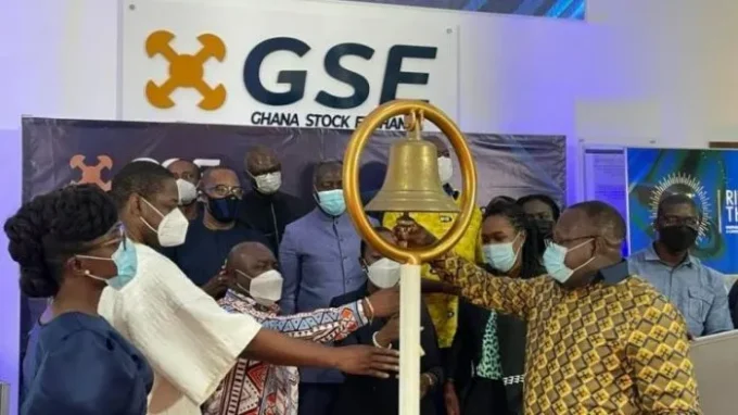 Ghana Stock Exchange trading floor showing rising stock charts and financial data, highlighting strong dollar gains driven by oil and banking sector rally amid global market selloff.