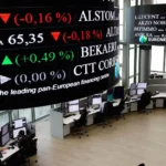 Euronext trading floor with electronic stock tickers and market screens, representing European stock markets, index movements, and investor sentiment.