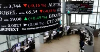 Euronext trading floor with electronic stock tickers and market screens, representing European stock markets, index movements, and investor sentiment.