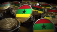 Metallic digital coins styled with the Ghana flag colours and black star, used to illustrate Ghana’s stablecoin regulation and virtual-asset market oversight.