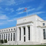 Federal Reserve Board seal displayed on a wall, representing US interest rate policy, Fed minutes, and market expectations in 2026.