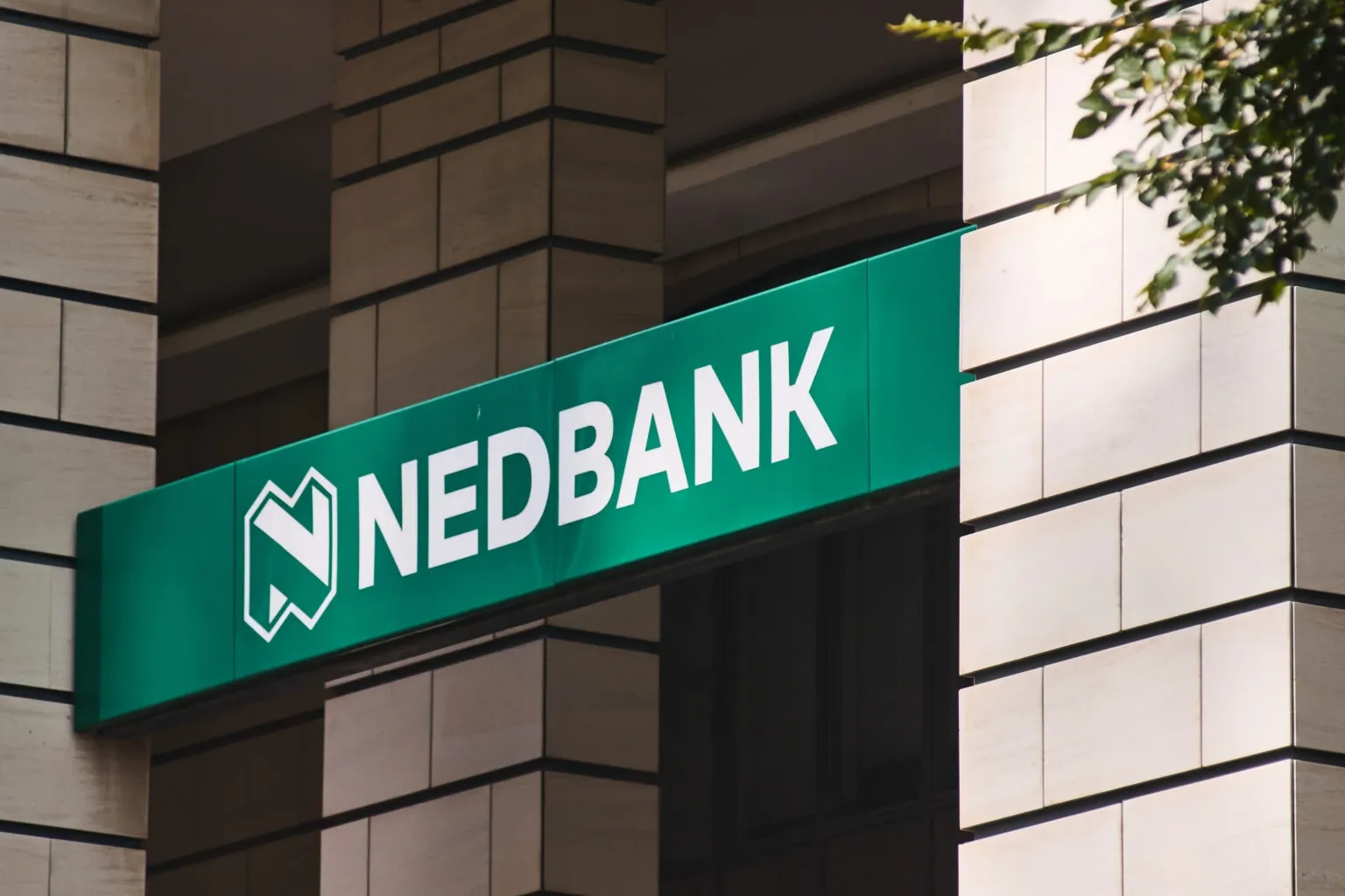 Nedbank signage on a building, representing Nedbank corporate bonds, South African bank funding and floating-rate note issuance.
