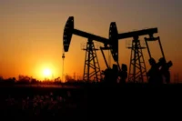 Silhouettes of oil pumpjacks at sunset, representing higher oil prices and their impact on Nigeria’s stock market rally and energy sector performance.