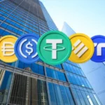 Digital stablecoin tokens displayed in front of glass financial buildings, representing bank-backed stablecoin payments, Open USD, and digital-dollar settlement infrastructure.