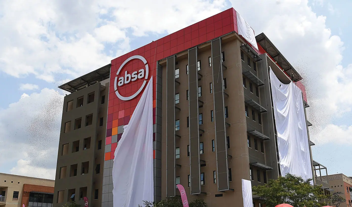 Photo of an Absa-branded office building with a large red Absa logo panel on the front facade. The image shows the bank’s corporate presence and is used to illustrate Absa Group’s planned sale of controlling stakes in First Assurance and Absa Life Assurance Kenya, while maintaining insurance distribution through Absa Bank Kenya.