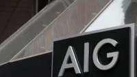 Close-up image of an AIG sign mounted on a building exterior, representing the global insurance group’s quarterly earnings, underwriting performance and investor outlook.