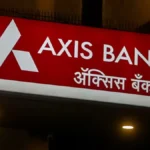 Photo of an illuminated red Axis Bank signboard with the bank’s logo and name displayed in English and Hindi. The image represents India’s banking sector and fixed deposit rate competition.