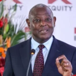 Article image showing an Equity Group executive speaking at a corporate event in front of Equity branding. The image represents Equity Group’s banking results, Kenya’s financial sector, regional banking growth and investor focus on profitability and asset quality.