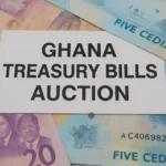 Ghanaian cedi banknotes beneath a card labelled Ghana Treasury Bills Auction.