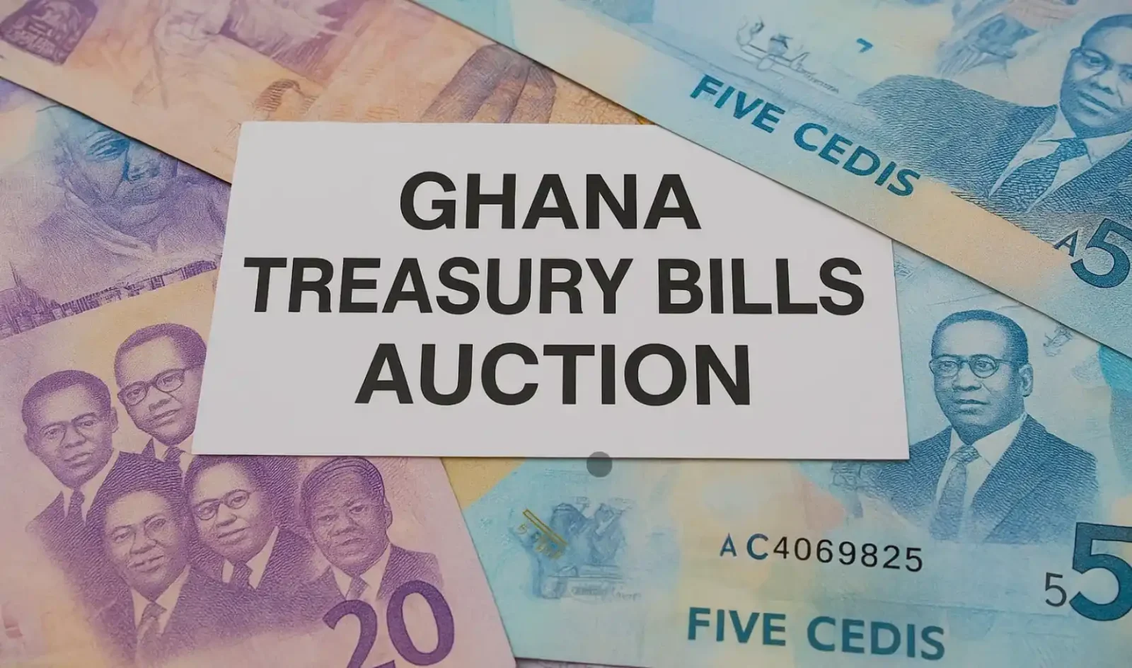 Ghanaian cedi banknotes beneath a card labelled Ghana Treasury Bills Auction.