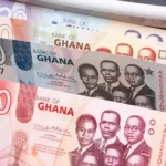 Ghanaian cedi banknotes showing cash and fixed-income investment themes, representing Treasury bill yields, reinvestment risk and Ghana money-market returns.