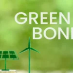 Green-themed image showing the words “Green Bonds” beside icons of a leaf light bulb, solar panel and wind turbine standing above stacks of coins. The image represents sustainable finance, climate-aligned debt issuance and investor access to green-bond markets.