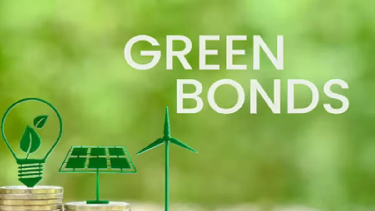 Green-themed image showing the words “Green Bonds” beside icons of a leaf light bulb, solar panel and wind turbine standing above stacks of coins. The image represents sustainable finance, climate-aligned debt issuance and investor access to green-bond markets.