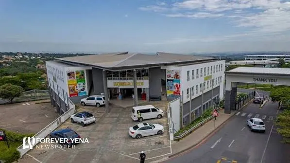 A landscaped commercial property with palm trees, parked cars and a white building, used to illustrate Dipula Properties, South African listed property, retail property acquisitions and real estate investment trusts.