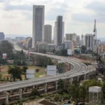 Wide cityscape image of Nairobi showing elevated roads, buildings and urban infrastructure, representing Kenya’s infrastructure development, public financing needs and the role of government infrastructure bonds.