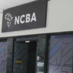Exterior image of an NCBA branch entrance with the NCBA logo displayed above the doorway, representing the Kenyan banking group’s financial results, dividend announcement and investor outlook.
