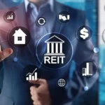 Businessperson interacting with digital REIT icons showing property, income, cash flow, investors and real estate investment assets.