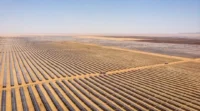 Aerial view of a large solar farm stretching across a desert landscape, used to illustrate renewable energy financing, solar infrastructure, Scatec’s green bond roadshow and investor interest in green bonds.