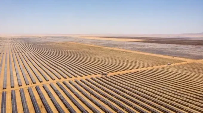 Aerial view of a large solar farm stretching across a desert landscape, used to illustrate renewable energy financing, solar infrastructure, Scatec’s green bond roadshow and investor interest in green bonds.
