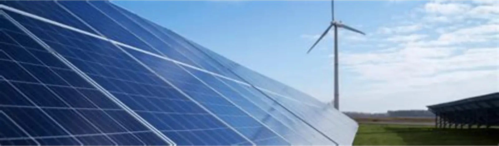 Solar panels in the foreground with a wind turbine in the background under a blue sky, representing renewable energy, clean-power infrastructure, climate finance and green-bond investment projects.