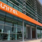Exterior view of a Unitel building with orange Unitel branding across a glass-fronted office façade in Angola.