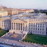 Aerial view of the U.S. Treasury building in Washington, D.C., used to illustrate stablecoin regulation, Treasury bill markets, reserve assets, U.S. financial policy and the GENIUS Act.